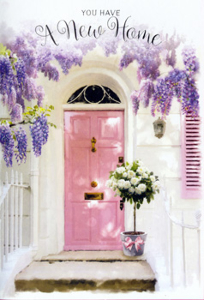 A charming pink front door, painted in a soft, rosy pastel, forms the heart of this inviting entrance, reminiscent of the characterful houses tucked along the residential roads off Cranley Gardens and around Muswell Hill. The door's colour is tender and reassuring, a muted, welcoming blush that sits comfortably between playful and elegant. Around it, wisteria hangs in abundant clusters from above, its lavender and lilac blooms spilling like a floral waterfall down each side of the frame. The blossoms are small and delicate, yet together they create a thick, tumbling curtain that appears both airy and rich, as if the gentle scent of springtime is drifting through the air. The walls on either side are whitewashed, lightly textured, and softly lit, making the pastel tones of the scene feel even more serene. The shutter, painted in a complementary pale pink, ties the composition together, almost like a thoughtfully chosen ribbon on a gift. At the doorstep, a metal bucket in a cool grey tone sits firmly on the worn stone step, filled to the brim with velvety white roses. Each rose is fully open, revealing layered petals edged with the faintest hint of cream, while sprigs of fresh green foliage weave between them, bringing life and movement to the arrangement. Around the bucket is tied a smooth pink ribbon, its bow slightly relaxed, suggesting a human touch and the care of a skilled local florist. The overall atmosphere is one of poised celebration and gentle anticipation, ideal for commemorating a housewarming in Muswell Hill or sending warm wishes to someone about to start a new chapter in a beloved London home, where every petal helps turn a brand-new address into somewhere that feels instantly lived in and loved.